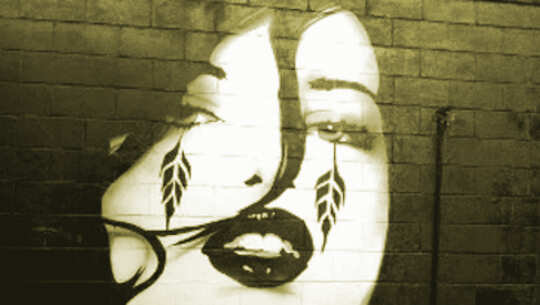 girl with tattoos on face and heavy make-up